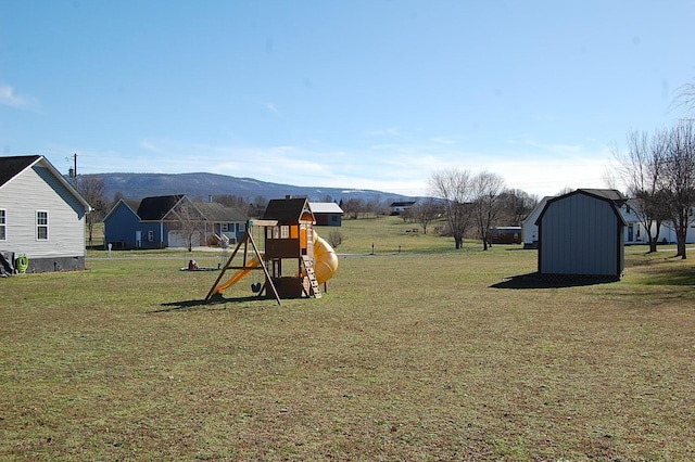 exterior space with a yard, a shed, and a mountain view