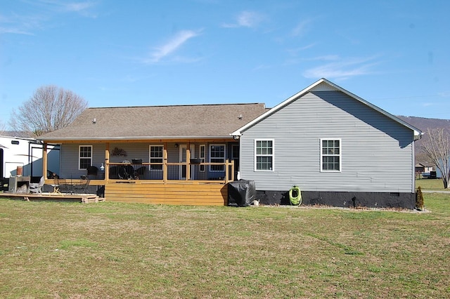 back of property featuring crawl space and a yard