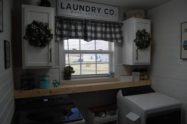 kitchen with white cabinets and independent washer and dryer