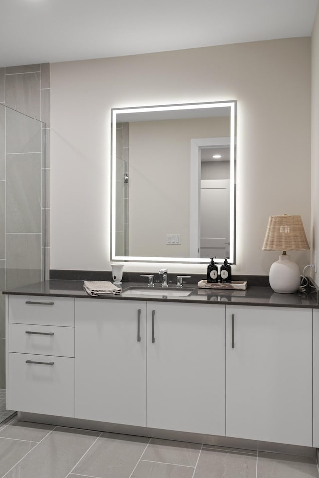 bathroom featuring vanity and a tile shower