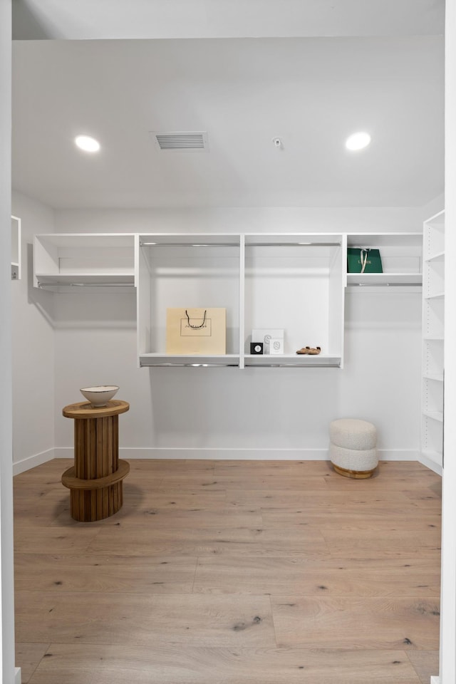 walk in closet with wood finished floors and visible vents