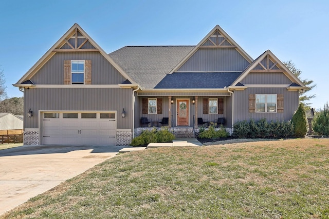 craftsman inspired home with a shingled roof, concrete driveway, covered porch, a front lawn, and brick siding