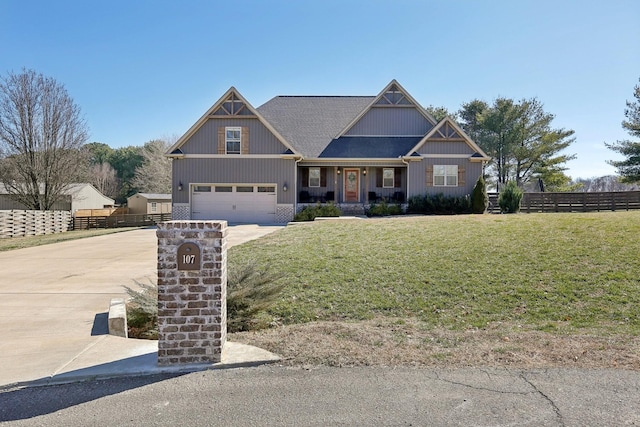 craftsman house with a garage, fence, driveway, and a front lawn