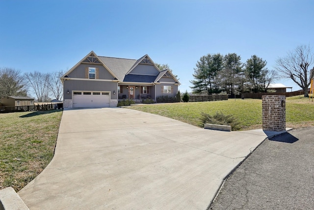 craftsman-style house with driveway, fence, and a front lawn