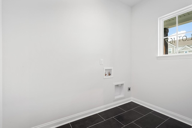 washroom with hookup for a washing machine, electric dryer hookup, dark tile patterned flooring, laundry area, and baseboards