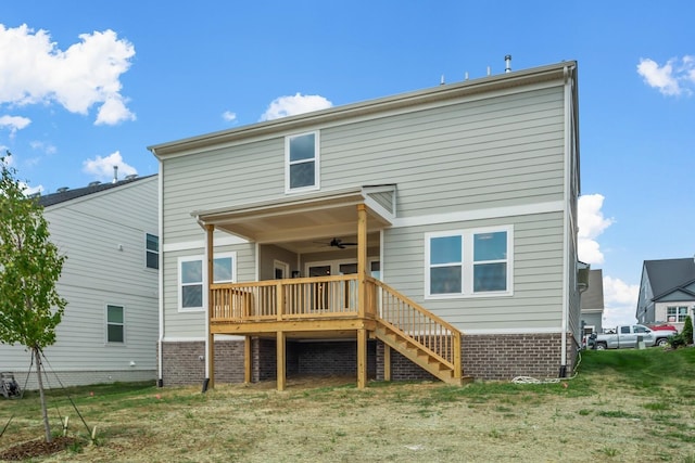 back of house featuring ceiling fan, a yard, stairway, and a wooden deck