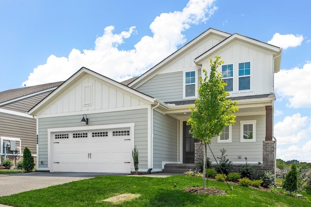 craftsman-style house with concrete driveway, board and batten siding, an attached garage, and a front yard