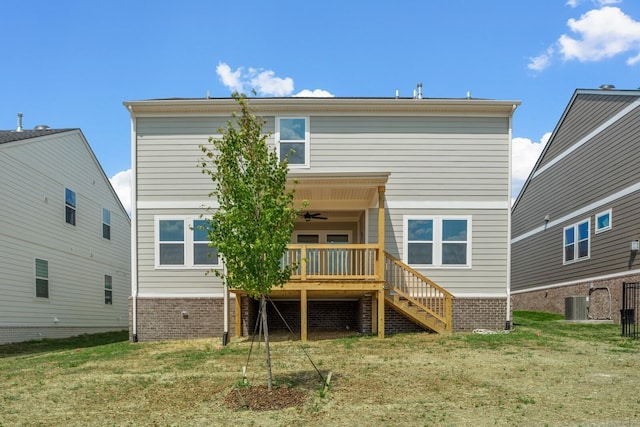 back of property with central air condition unit, a lawn, stairway, and a ceiling fan