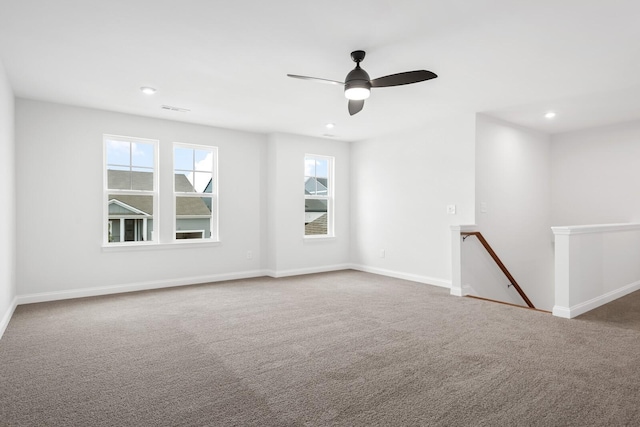 carpeted empty room featuring a ceiling fan, recessed lighting, visible vents, and baseboards