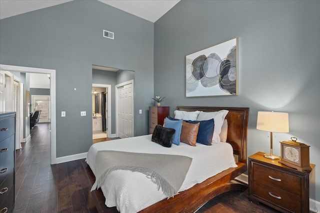 bedroom featuring dark wood-style flooring, a closet, visible vents, high vaulted ceiling, and baseboards