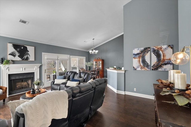 living room featuring visible vents, lofted ceiling, dark wood-style floors, ornamental molding, and a fireplace