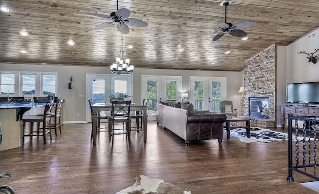 living area featuring french doors, dark wood-style flooring, a fireplace, and wooden ceiling