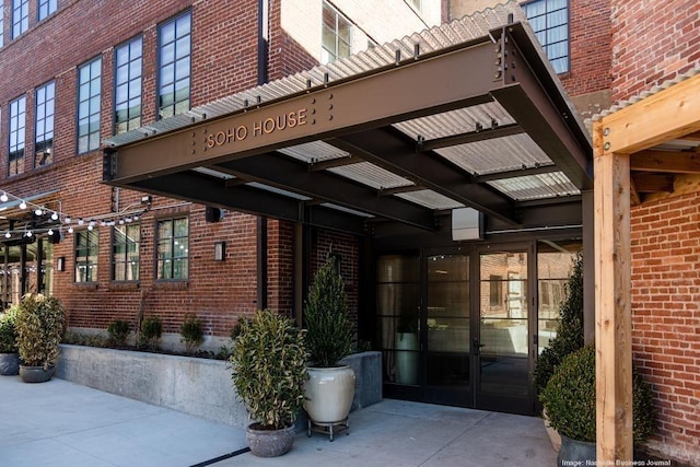 entrance to property featuring brick siding