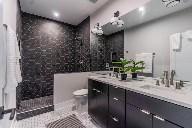 bathroom featuring tile patterned flooring, a sink, toilet, and double vanity