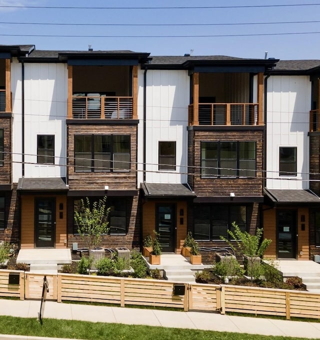 view of front of home with a fenced front yard and board and batten siding