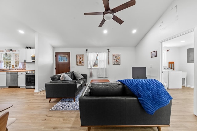 living area featuring lofted ceiling, light wood-type flooring, and a wealth of natural light