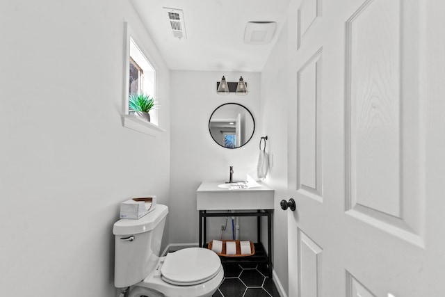 bathroom with visible vents, toilet, and tile patterned floors