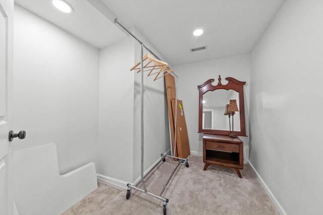 spacious closet featuring light carpet and visible vents