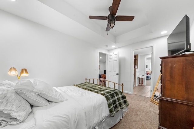 bedroom featuring recessed lighting, a raised ceiling, light colored carpet, ceiling fan, and baseboards