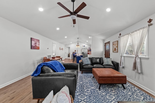 living area with vaulted ceiling, recessed lighting, wood finished floors, and baseboards