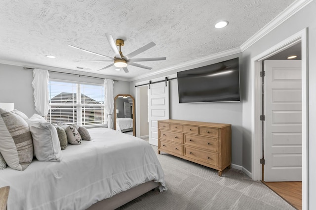 bedroom with a barn door, baseboards, ceiling fan, a textured ceiling, and crown molding