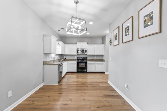 kitchen featuring stainless steel appliances, light wood finished floors, white cabinets, and baseboards