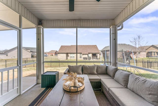 sunroom featuring a residential view