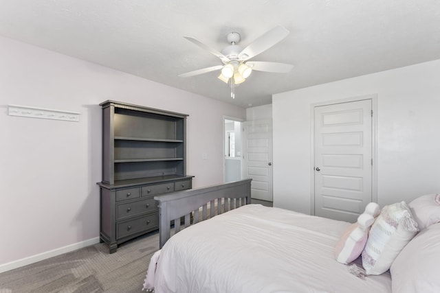 bedroom with light carpet, a closet, baseboards, and a ceiling fan