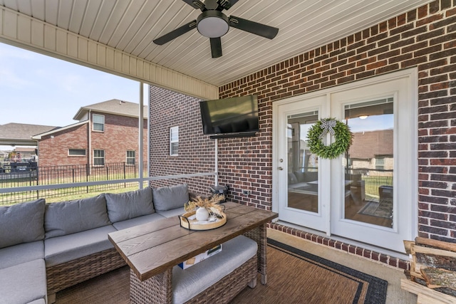 view of patio / terrace featuring fence, an outdoor hangout area, and a ceiling fan