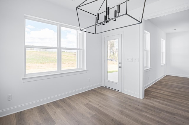 interior space with baseboards and wood finished floors