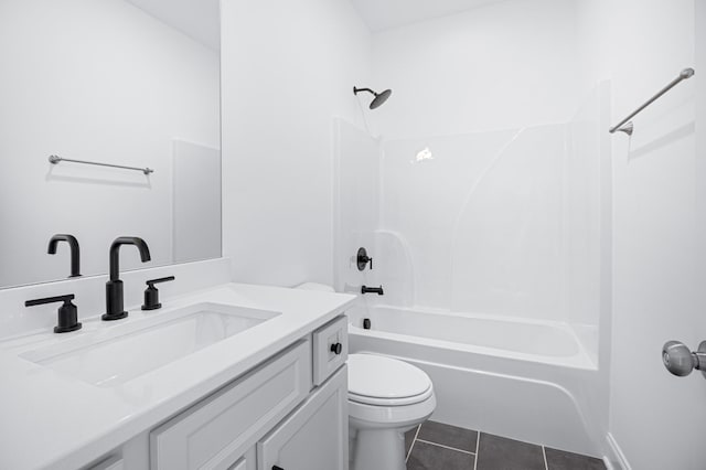 bathroom featuring toilet, tile patterned flooring, vanity, and bathing tub / shower combination