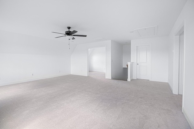 additional living space featuring light carpet, attic access, vaulted ceiling, and a ceiling fan