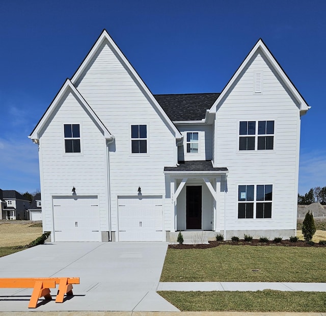 modern farmhouse style home featuring a garage, driveway, and a front lawn