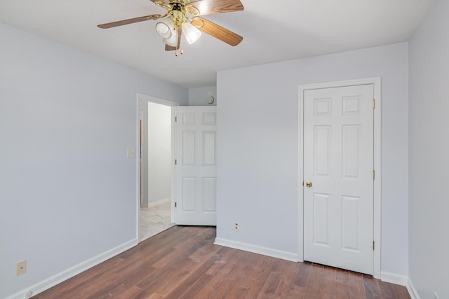 unfurnished bedroom featuring a ceiling fan, baseboards, and wood finished floors