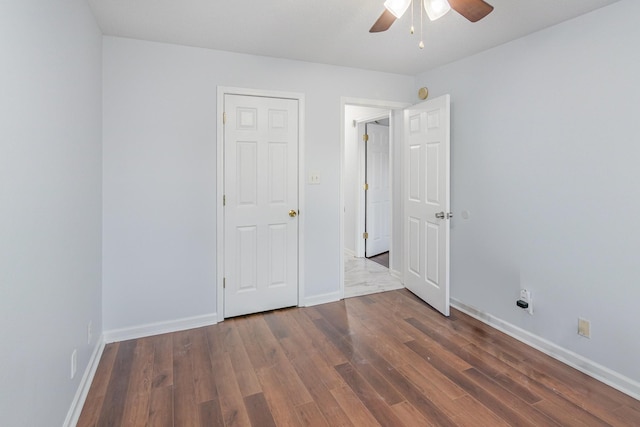 unfurnished bedroom featuring ceiling fan, baseboards, and wood finished floors