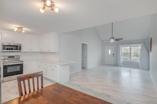 kitchen with marble finish floor, stainless steel appliances, light countertops, open floor plan, and white cabinetry