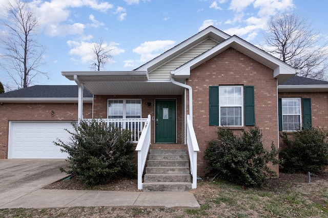 single story home with a garage, covered porch, brick siding, and driveway