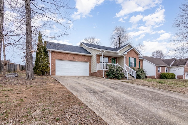 single story home featuring brick siding, a shingled roof, fence, a garage, and driveway