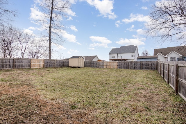 view of yard featuring a shed, an outdoor structure, and a fenced backyard