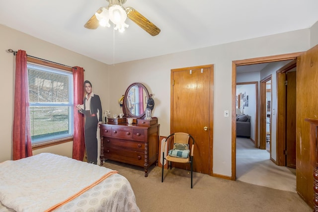 bedroom featuring ceiling fan, baseboards, and light colored carpet