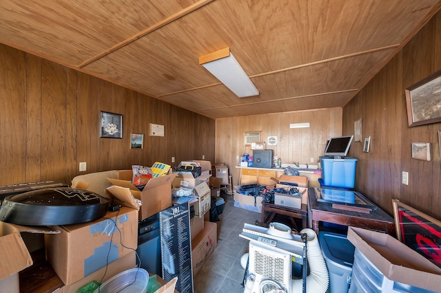 interior space featuring dark tile patterned flooring, wooden ceiling, and wood walls