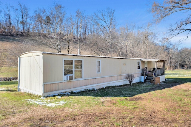 view of side of home featuring a yard