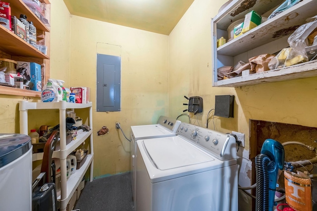 clothes washing area with laundry area, electric panel, and separate washer and dryer