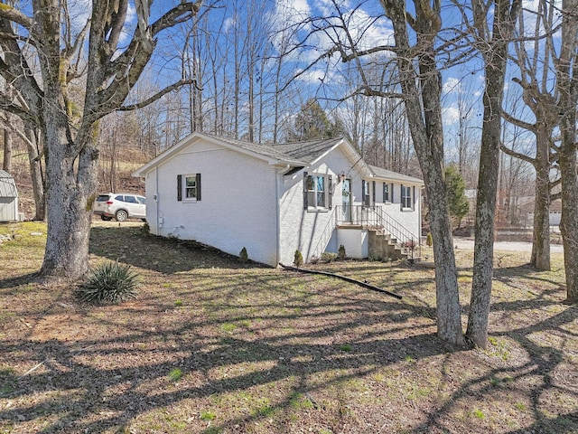 view of side of home featuring brick siding