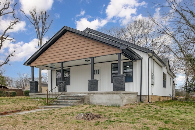 bungalow with a front yard and covered porch