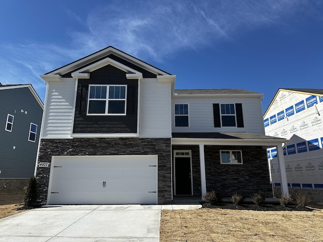 view of front of house with a garage, stone siding, and driveway