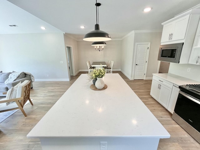 kitchen with white cabinets, a kitchen island, and stainless steel appliances