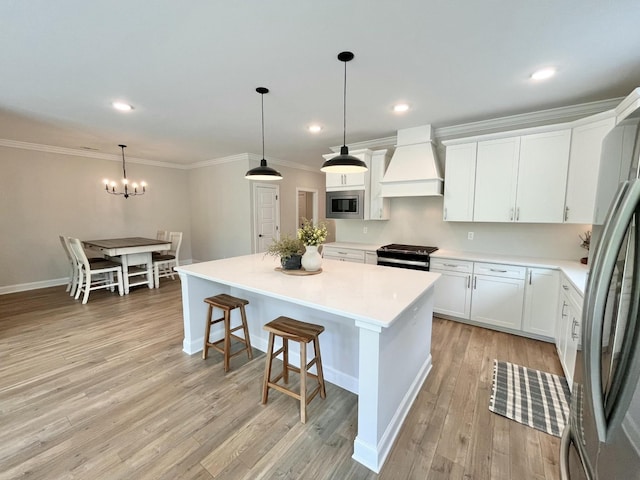 kitchen with stainless steel appliances, a kitchen island, white cabinets, light countertops, and custom range hood