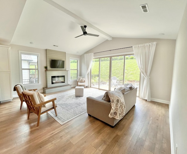 living area featuring a fireplace, visible vents, and light wood-style floors