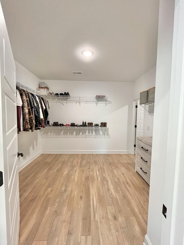 spacious closet featuring light wood finished floors and visible vents